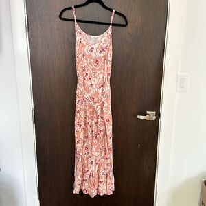 Mid length Sundress with adjustable straps. Elastic in back and tie in front.